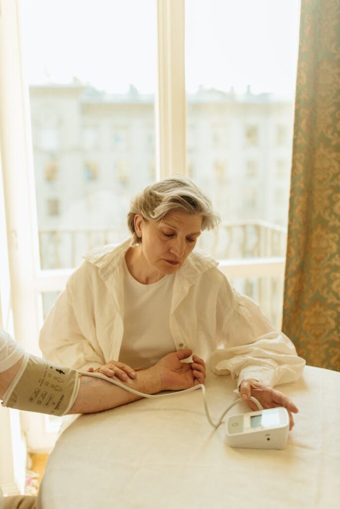 Woman Checking the Blood Pressure of Person